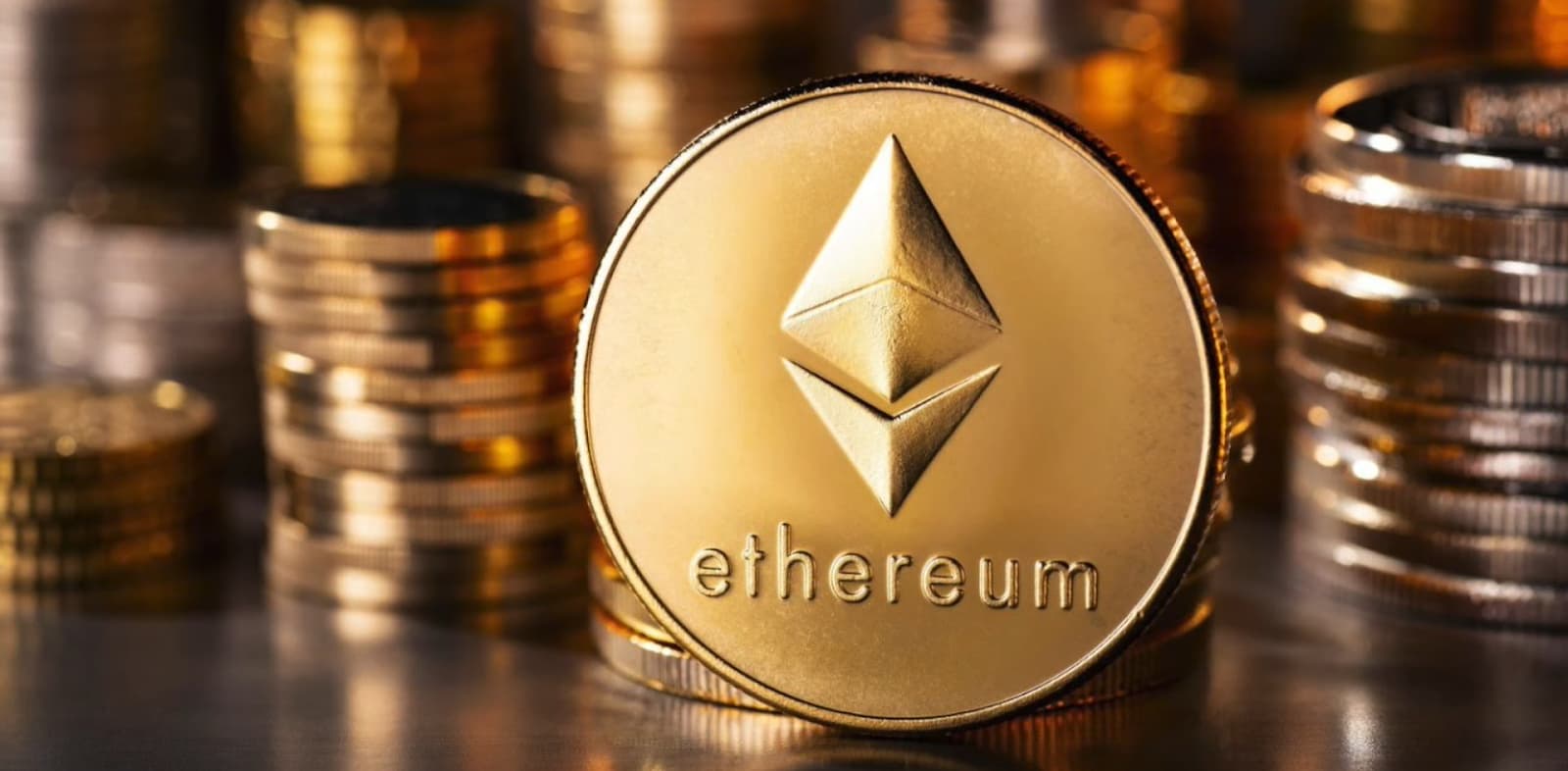 A golden Ethereum coin stacked among other blurred coins